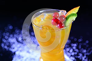 Close-up orange juice with fruits and ice cubes in a glass Â 